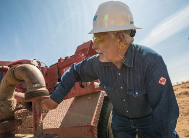 An industry employee tests field equipment