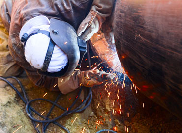 New Pipeline Construction Employee works on pipe sections